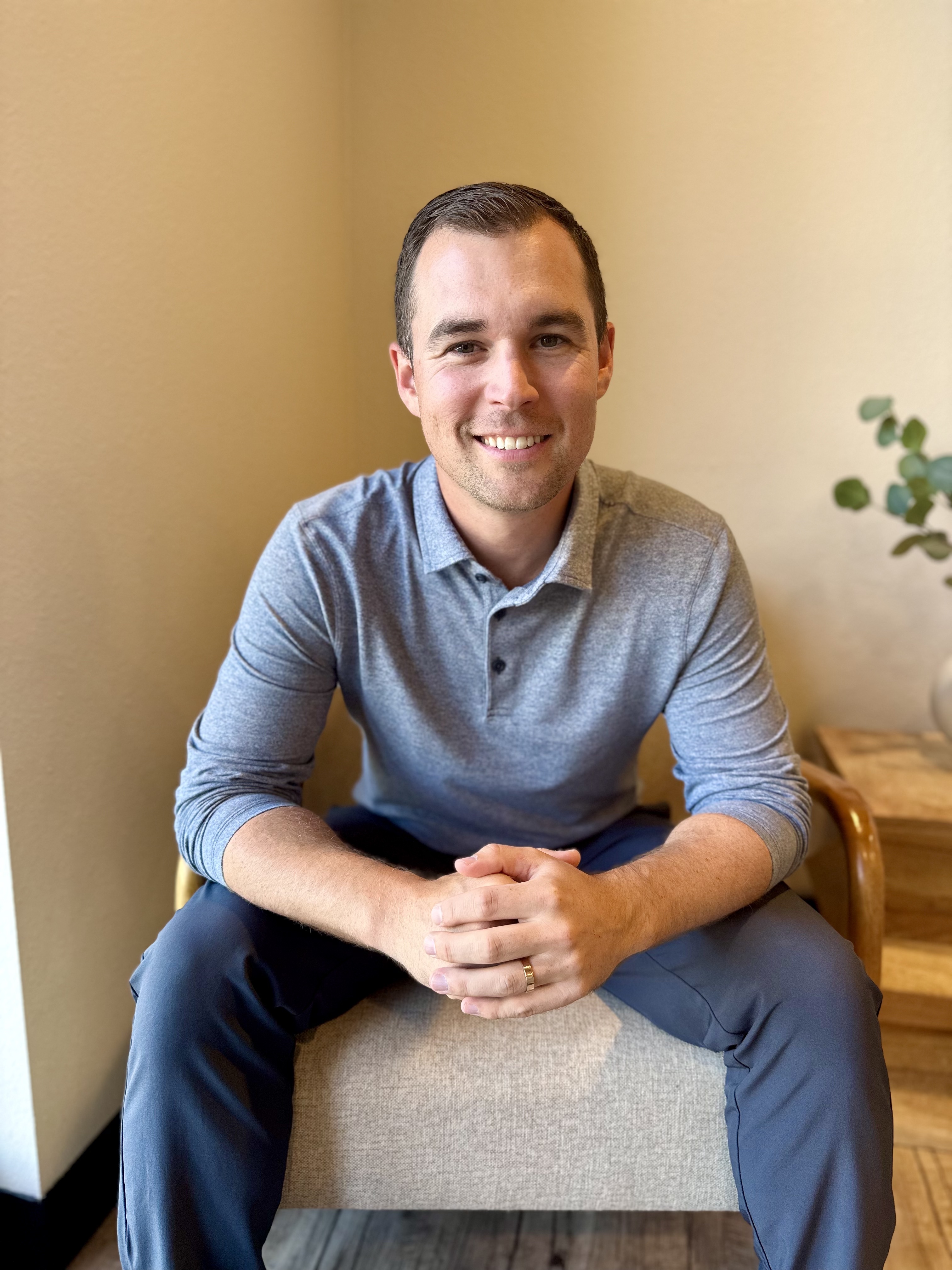 Dr. Brock Martin smiling, seated in the Martin Chiropractic office in Fort Collins